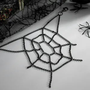Detailed close-up of a Gothic black spider web chain accessory for clothes