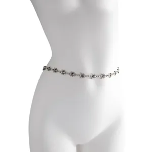 Detailed view of hip-hop style silver spider body chain worn on a mannequin waist.