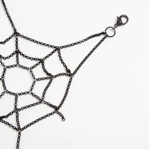 Close-up detail of gothic punk style black metal spider web body chain with secure clasp