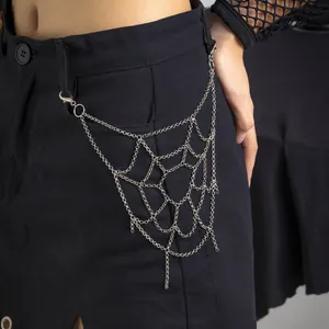 Gothic punk silver spiderweb pant chain accessory with layered tassels on model