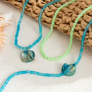 Close-up of bohemian beaded anklets with iridescent shell pendants for beach vacation