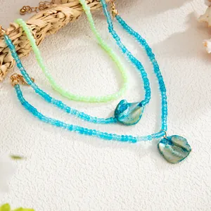 Close-up of bohemian colorful seed bead anklets featuring iridescent shell pendants