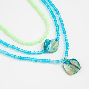Detail showing Bohemian beach anklets with colorful seed beads and shell pendants