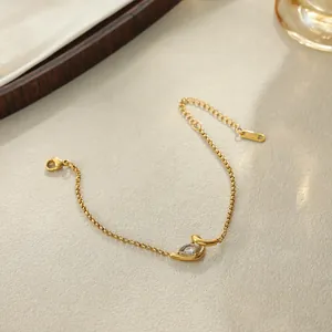 Vue détaillée d'un collier en acier doré avec pendentif en zircon en forme de goutte