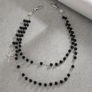 Detailed view of double-layered hip-hop pants chain with black beads and silver cross pendant.