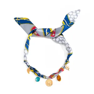 Bohemian printed silk scarf necklace featuring gold coin and colorful resin leaf charms