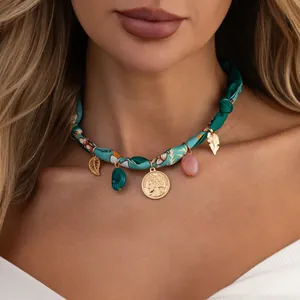 Detail view of Bohemian printed silk scarf choker with gold coin and resin charms