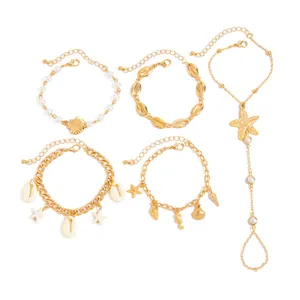 Conjunto de 5 joyas doradas con temática oceánica, estrellas de mar y perlas