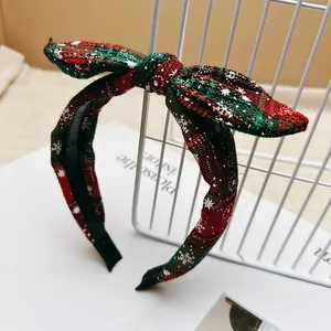 Christmas festive red and green plaid bow headband with white snowflake patterns for women