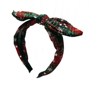 Christmas plaid bow headband with white snowflake pattern in festive red and green