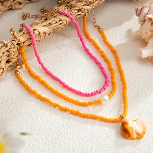 Close-up of Bohemian colorful rice bead anklets with shell and pearl pendant detail