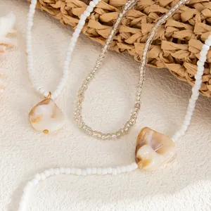 Detailed view of bohemian seed bead anklets with organic shell pendants for beach