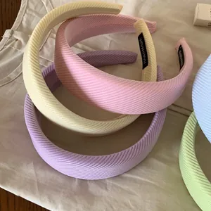 Set of pastel padded headbands in macaron colors with ribbed fabric texture.