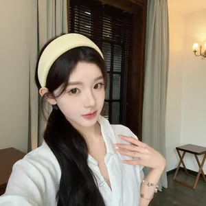 Elegant Korean style wide fabric headband in cream yellow worn by model to enhance hair volume
