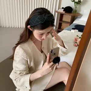 Retro black plaid knotted headband for women shown in a lifestyle mirror selfie