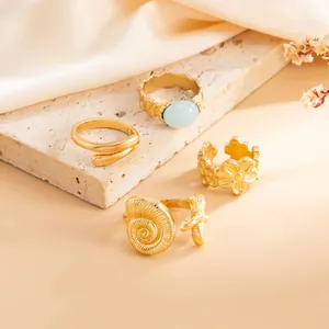 Set de anillos ajustables dorados tema océano con estrella de mar, caracola y piedra azul