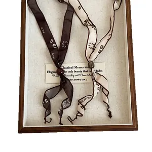 Elegant vintage printed ribbon scarf necklace with adjustable bead inside wooden jewelry tray