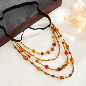 Close-up detail of multi-layer Bohemian beaded leg chain with black elastic band
