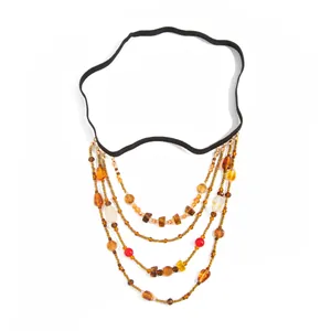 Bohemian multi-layer beaded leg chain with amber accents and elastic black band detail