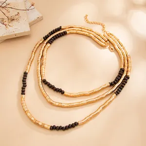 Vintage style textured gold metallic and dark bead triple layered necklace with adjustable chain