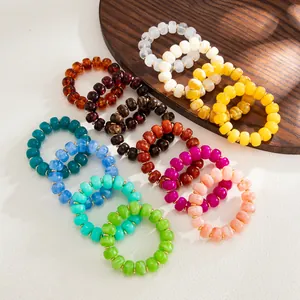 Detailed view of bohemian colorful marbled resin rings set in various vibrant shades