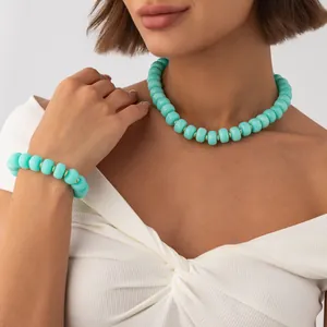 Close-up of bohemian turquoise resin bead necklace and bracelet set on a model