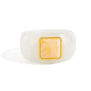Detailed close-up of retro transparent resin bangle featuring a marbled square gold insert