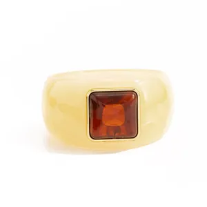 Close-up of vintage resin bangle with a square marbled amber-like center stone