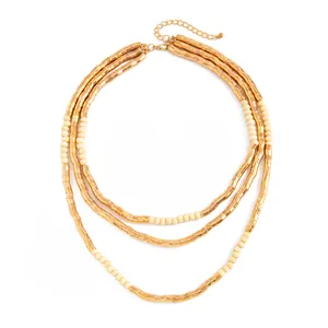 Elegant multi-layer textured golden metallic and cream bead necklace in retro style.