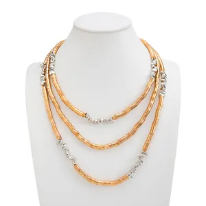 Detailed view of triple-layered metallic bead necklace with gold and silver color blocking