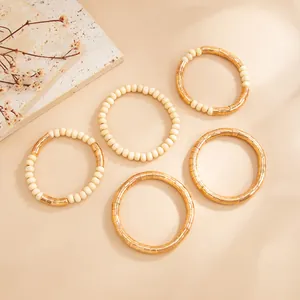 Detailed macro view of textured gold metallic and cream bead choker necklaces set