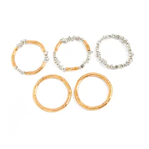 Set of five metallic textured chokers in gold and silver tones with a minimalist look.
