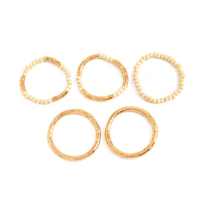 Set of 5 textured gold metallic and cream seed bead stacking necklaces on white background