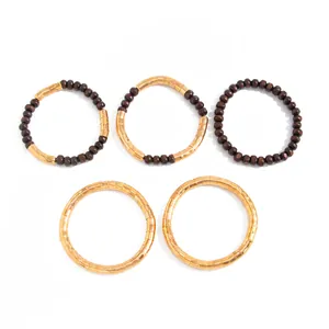 Detail of vintage gold metallic and dark brown wood bead stacking necklace jewelry set
