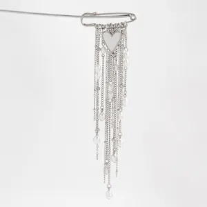 Elegant silver safety pin brooch featuring white heart pendant and pearl tassel chains