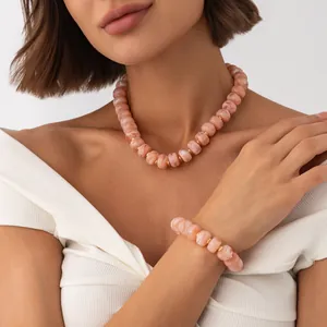 Bohemian marbled pink resin bead necklace and bracelet jewelry set worn by a model