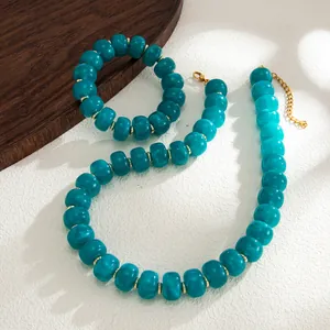 Detail of bohemian teal marbled resin bead necklace and bracelet jewelry set