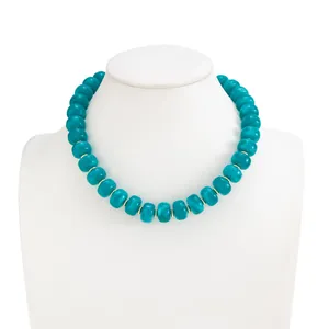 Detailed view of bohemian teal marbled resin bead necklace on white bust display