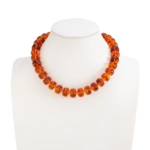 Detail view of bohemian resin bead necklace featuring amber-colored translucent beads