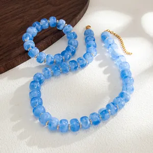 Macro view showing blue marbled resin beads with gold stainless steel spacers on jewelry set