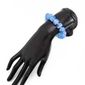 Detailed view of a blue marbled resin bead bracelet displayed on a black hand stand