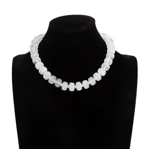 Elegant bohemian necklace featuring marbled white resin beads on a black mannequin