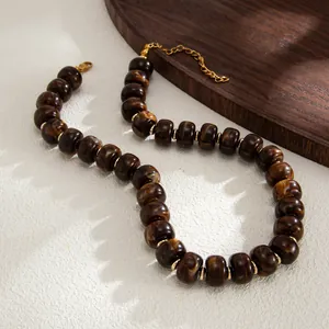 Close-up of bohemian marbled brown resin beads and gold spacers on a necklace