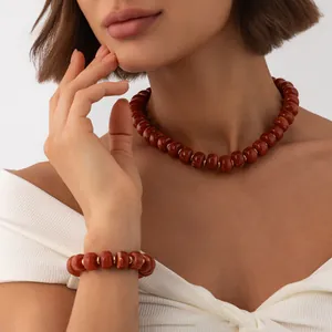 Detailed view of bohemian marbled reddish-brown resin bead necklace and bracelet set