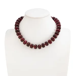 Detail view of Bohemian marbled burgundy resin necklace with gold stainless steel beads