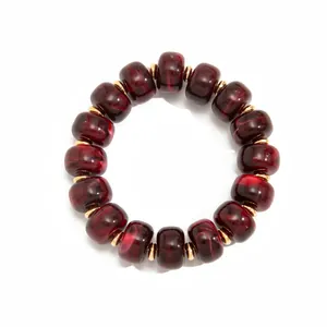 Bohemian dark red marbled resin bead necklace with elegant gold spacers macro detail view