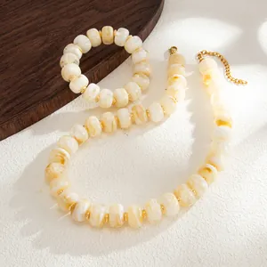 Detail shot of Bohemian marbled resin bead necklace and bracelet set with gold hardware.