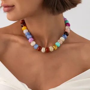 Close-up of bohemian colorful marbled resin bead necklace with stainless steel spacers