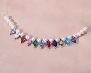 Primer plano detallado de colgantes de circonita marquesa de colores con perlas blancas