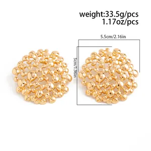 Detailed view of hollow honeycomb mesh stud earrings with liquid gold geometric texture